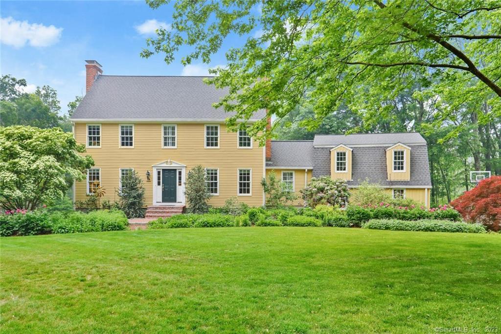 18 Willow Court Ridgefield, CT 06877 - Photo 1 of 1 a front view of a house with a garden and plants
