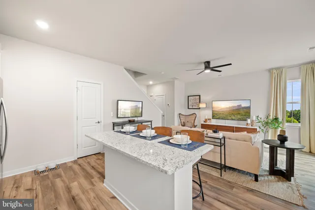 a kitchen with a refrigerator a stove a sink and a dining table