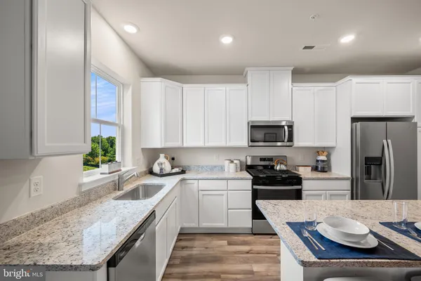 a kitchen with a sink stove and refrigerator