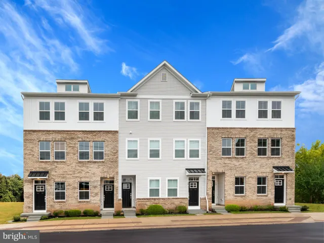 a front view of a building with a yard