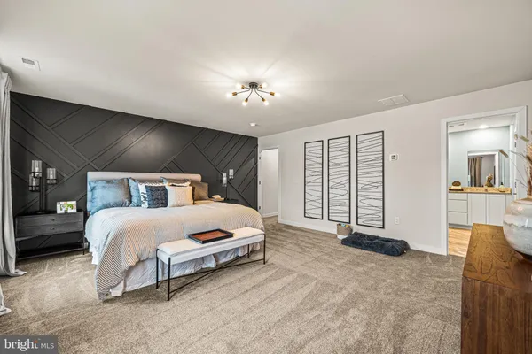 a spacious bedroom with a bed and a couch