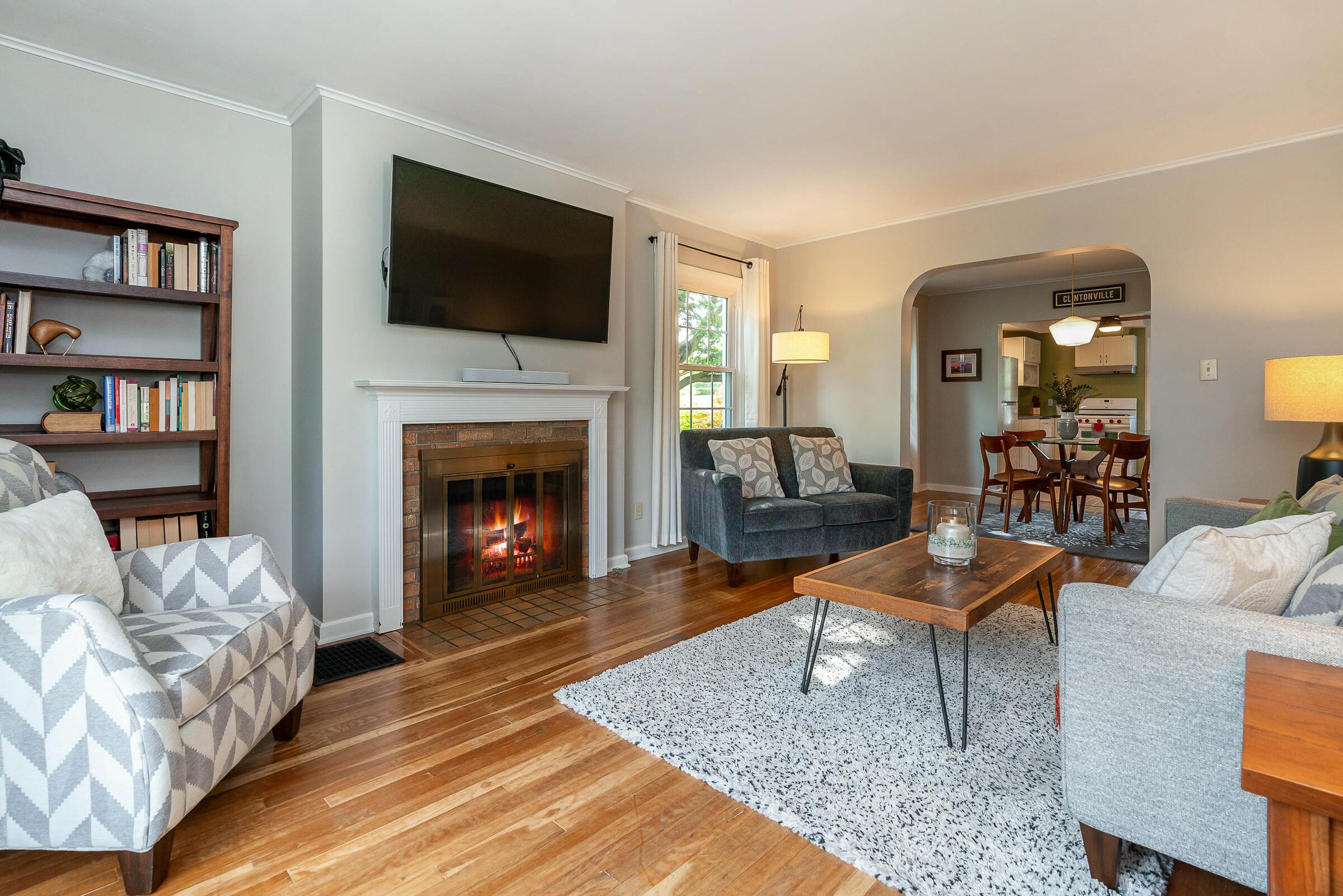 259 Acton Road Columbus, OH 43214 - Photo 6 of 30 Refinished wood floors and a gas log fireplace in the living room set the tone for this move-in ready home.