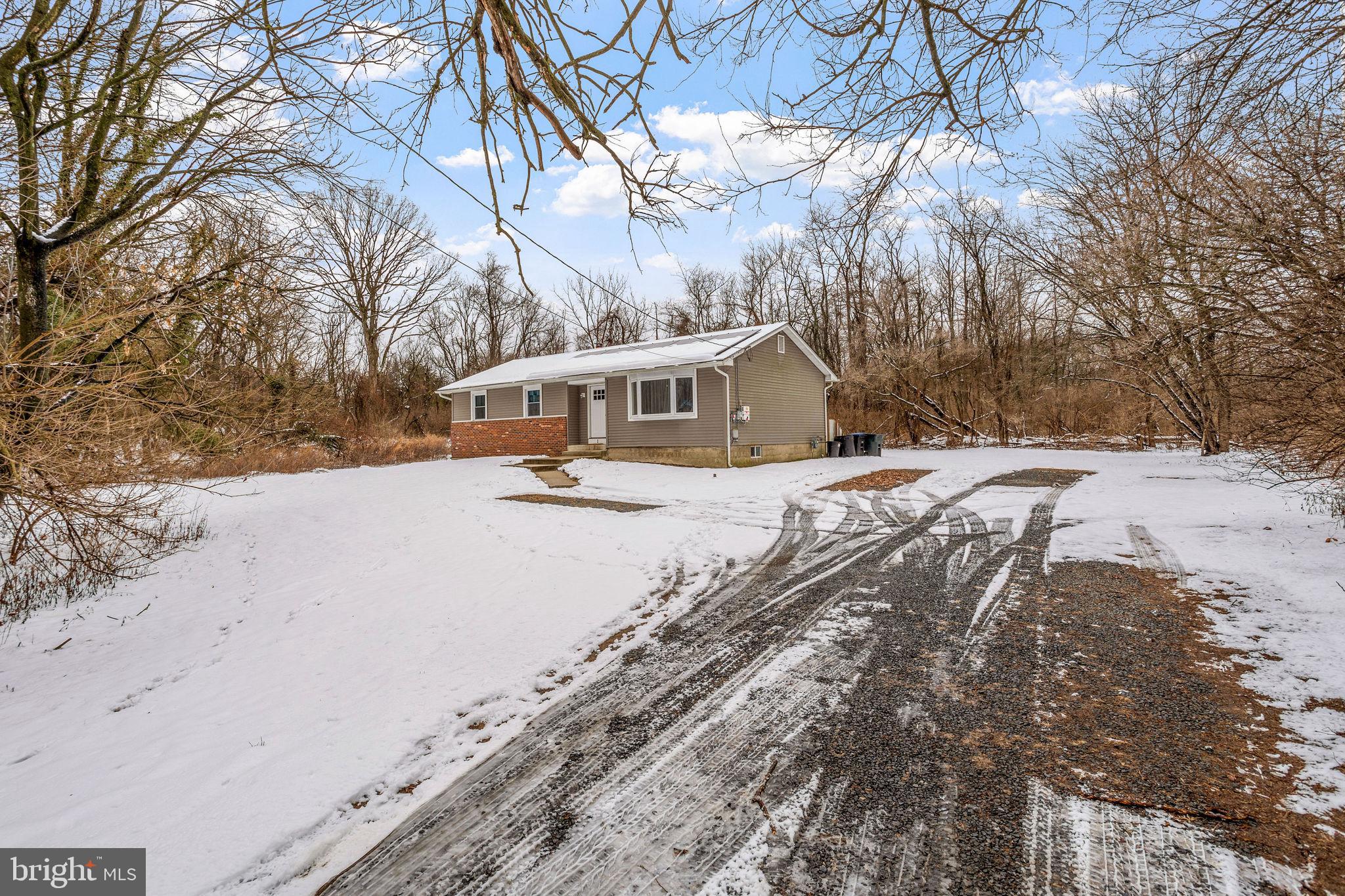 a view of a large white house with a snow on the road