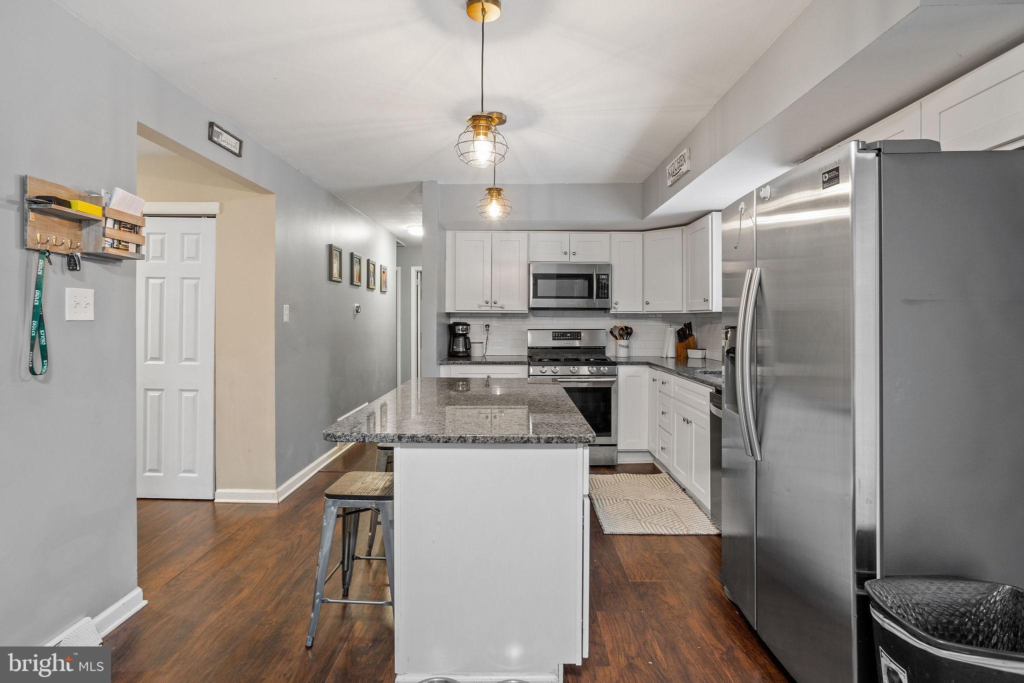 1 Ruby Avenue Sewell, NJ 08080 - Photo 15 of 32 a kitchen with kitchen island a refrigerator sink and wooden floor