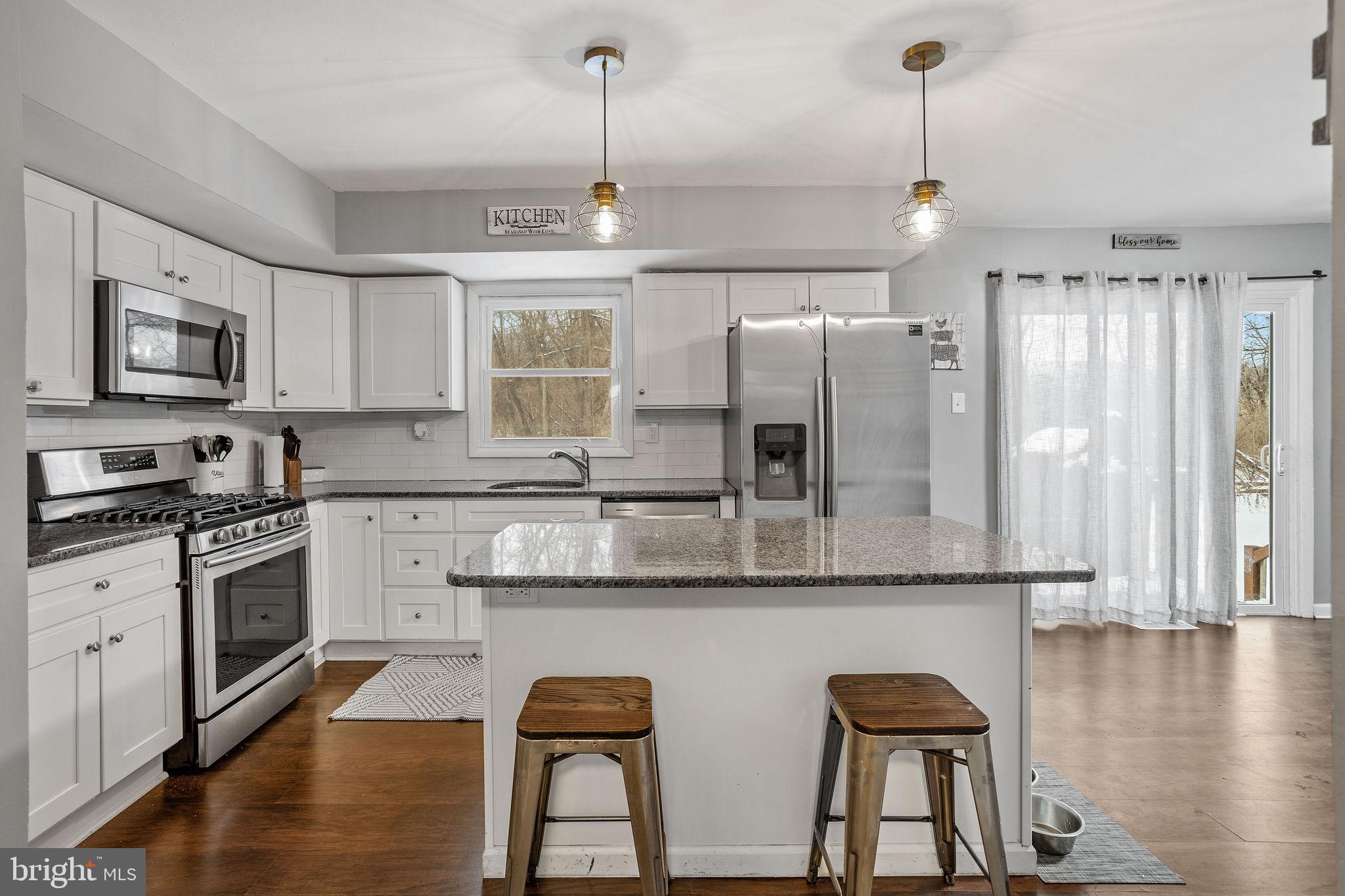 1 Ruby Avenue Sewell, NJ 08080 - Photo 18 of 32 a kitchen with stainless steel appliances granite countertop a stove a sink and a refrigerator