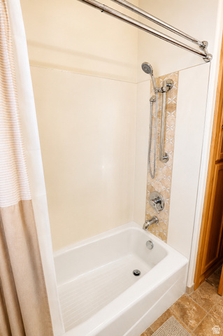 1055 North 1000 East Mapleton, UT 84664 - Photo 40 of 112 Bathtub and shower combination featuring a tiled accent wall and chrome fixtures