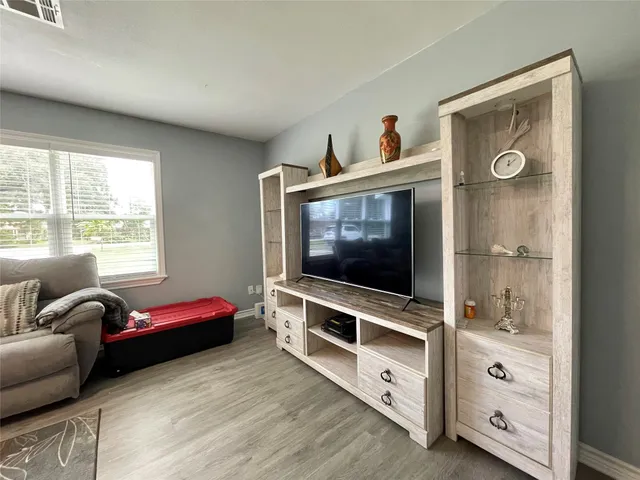 a living room with furniture and flat screen tv
