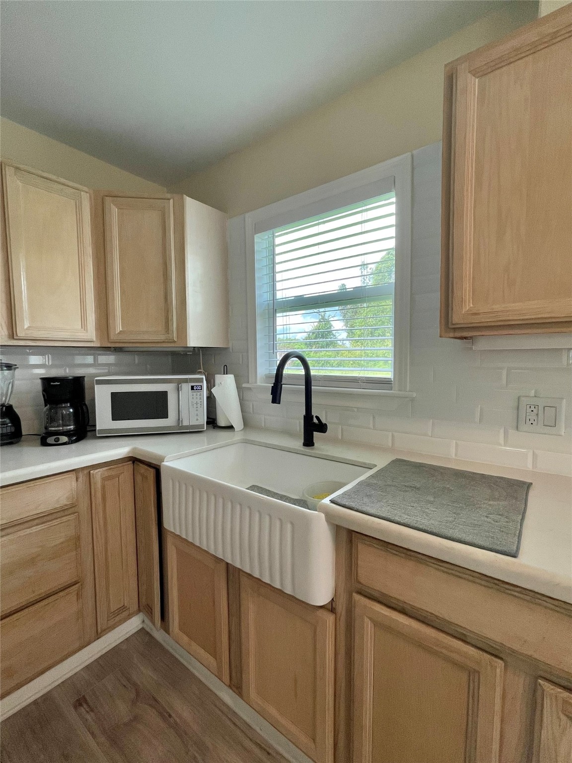 1116 Lake Street Clute, TX 77531 - Photo 16 of 34 a kitchen with stainless steel appliances granite countertop a sink a stove and white cabinets with wooden floor