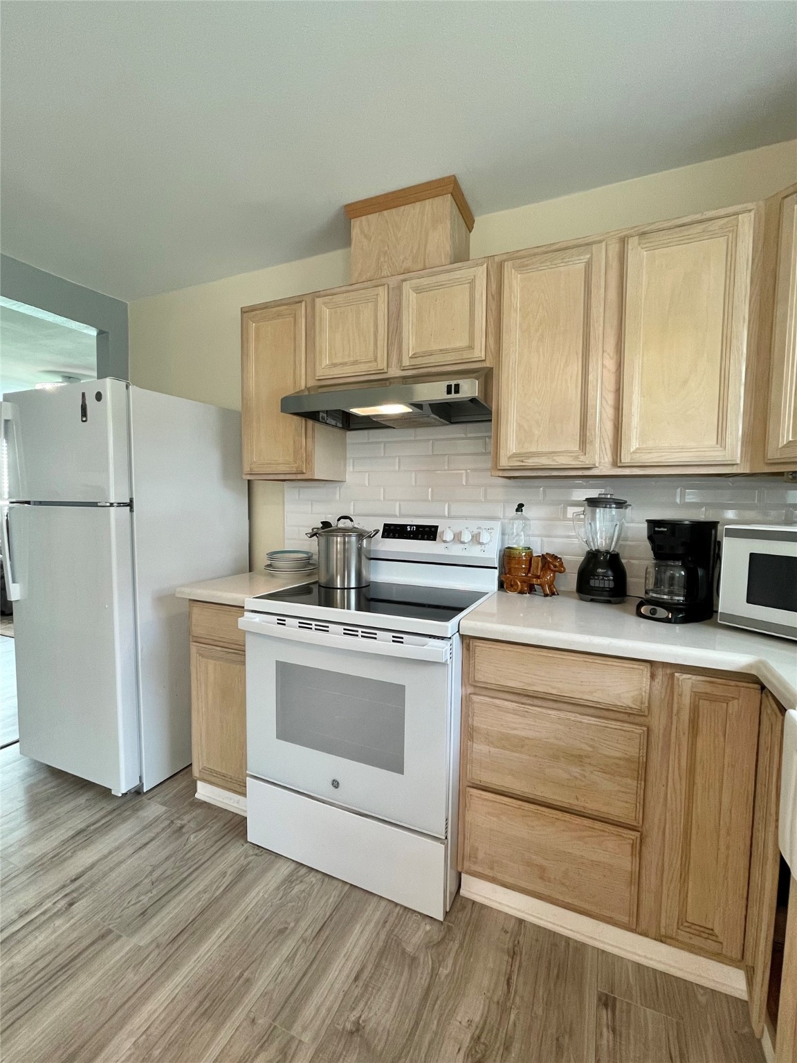 1116 Lake Street Clute, TX 77531 - Photo 17 of 34 a kitchen with a white cabinets and white appliances