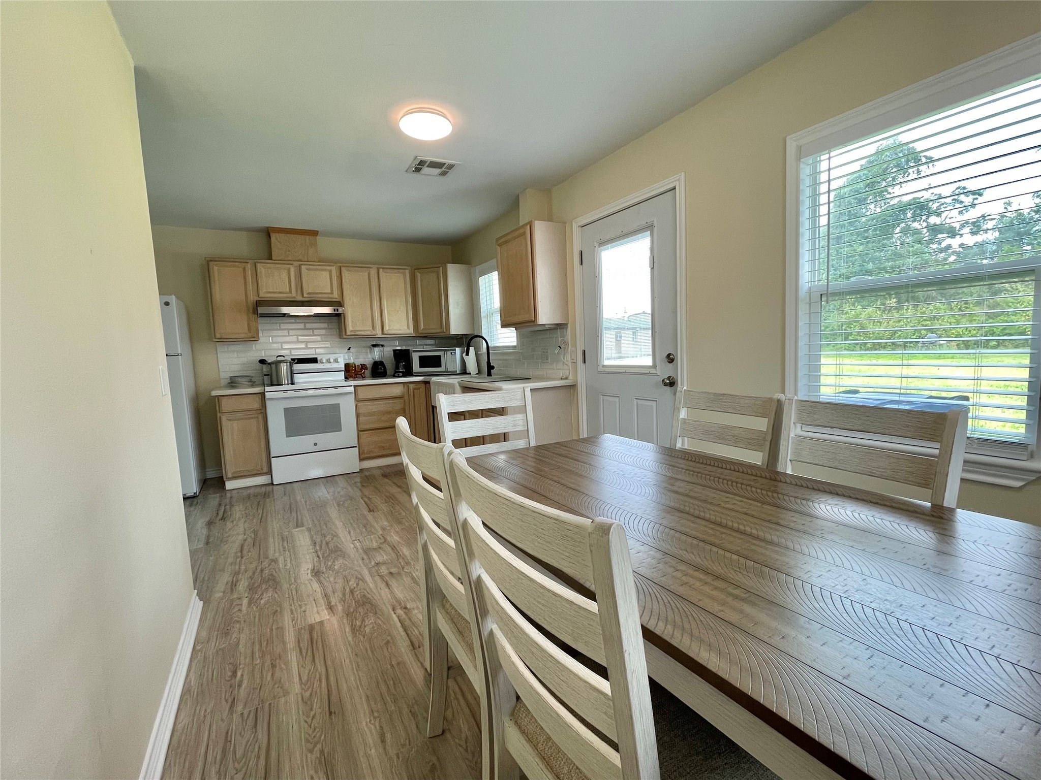 1116 Lake Street Clute, TX 77531 - Photo 18 of 34 a kitchen with wooden floors and wooden cabinets