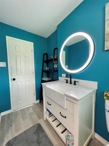 a room with a sink and a mirror