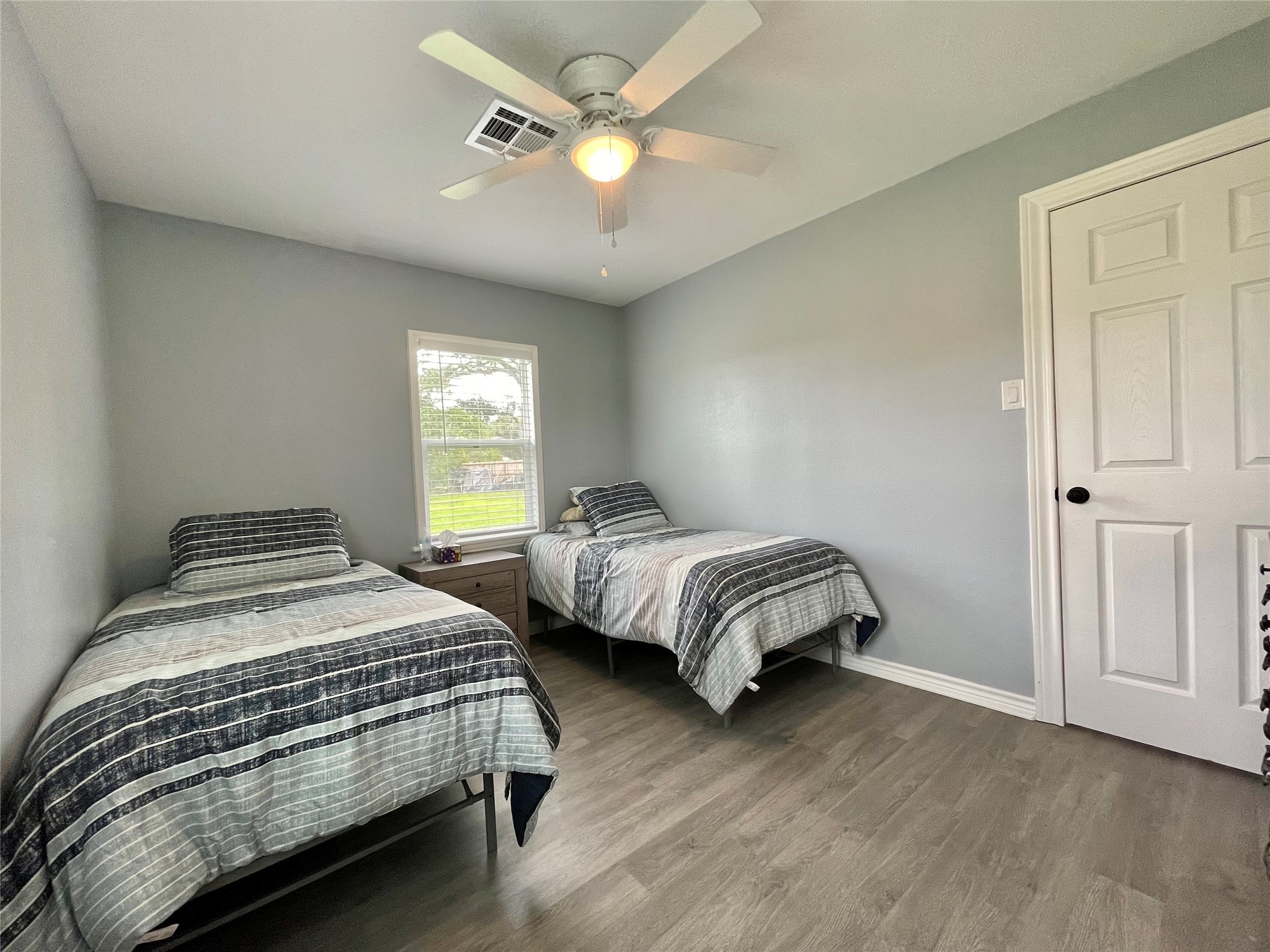 1116 Lake Street Clute, TX 77531 - Photo 25 of 34 a bedroom with a bed chandelier and a window