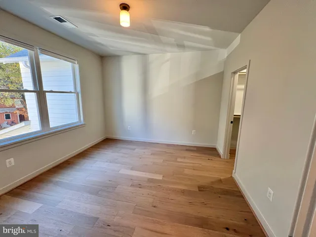 a bathroom with a sink a toilet a mirror and shower