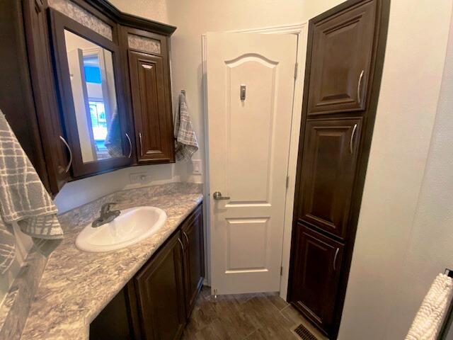 84136 Ave 44, Unit 694 Indio, CA 92203 - Photo 19 of 20 a bathroom with a granite countertop sink and a mirror