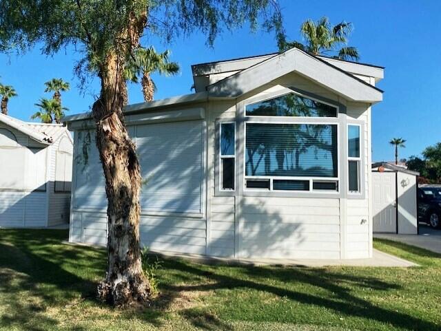 84136 Ave 44, Unit 694 Indio, CA 92203 - Photo 3 of 20 a front view of a house with garden
