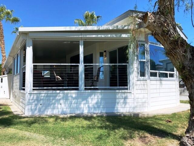 84136 Ave 44, Unit 694 Indio, CA 92203 - Photo 4 of 20 a front view of a house with a yard