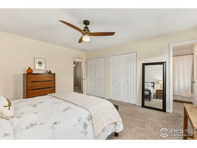 a bedroom with a bed and a ceiling fan