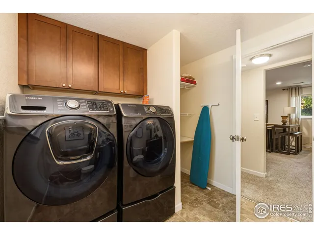 a utility room with sink dryer and washer