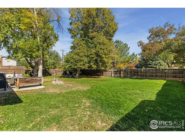 a view of yard with swimming pool and green space