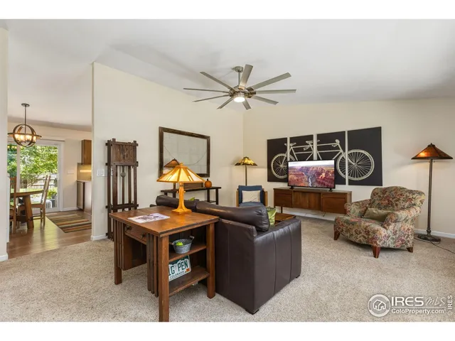 a living room with furniture a chandelier and a dining table