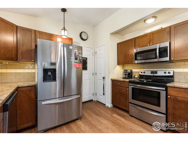 a kitchen with stainless steel appliances and wooden cabinets