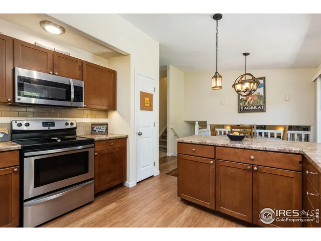 a kitchen with stainless steel appliances a stove a sink and a microwave