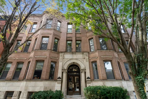 a view of a brick building with large windows