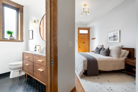 a spacious bedroom with a bed and a window