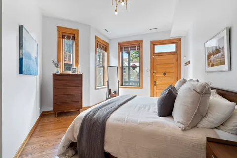 a bedroom with a bed and wooden floor