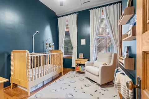 a bedroom with furniture and a large window