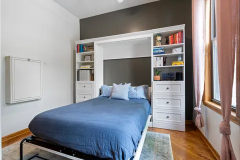 a bedroom with a bed and dresser