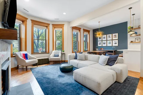 a living room with furniture and large windows