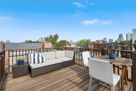 a view of roof deck with patio