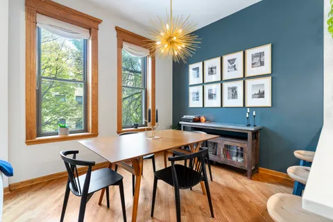 a view of a dining room with furniture and wooden floor