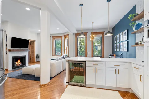 a large white kitchen with a large window