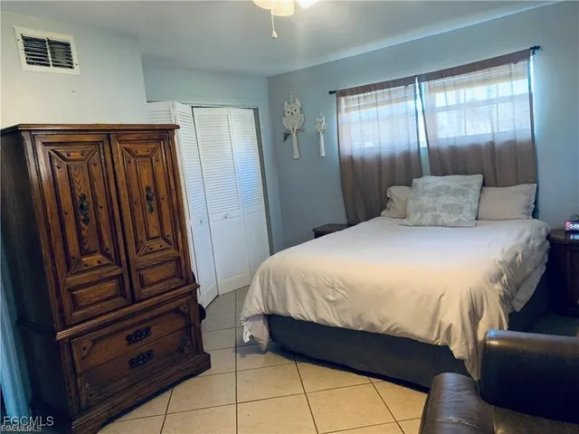 a bedroom with a bed and a mirror