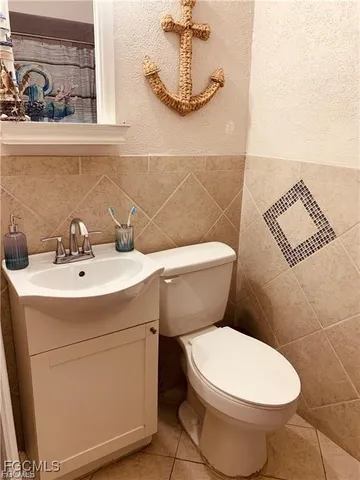 a white toilet sitting next to a bathroom sink