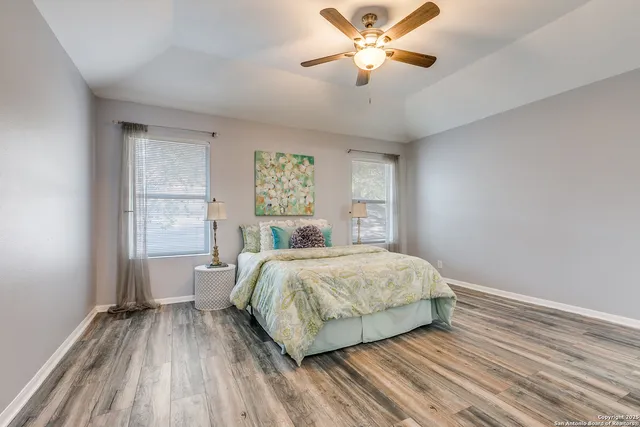 a bedroom with a large bed and a chandelier