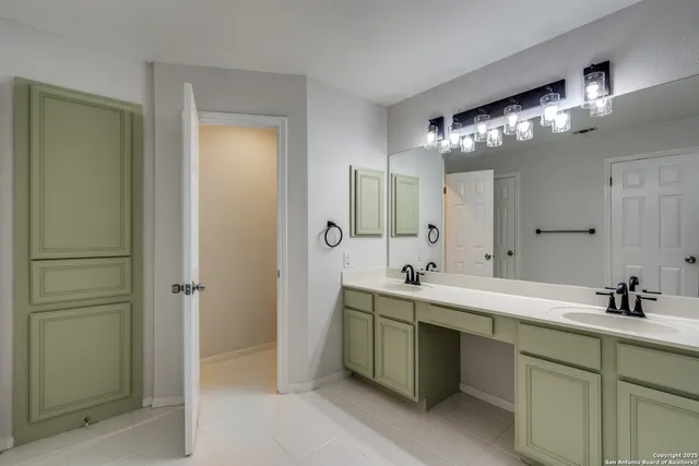 a bathroom with double sink and a mirror