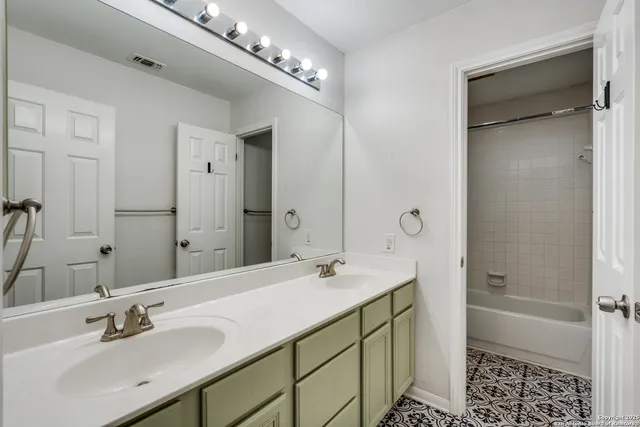 a bathroom with a sink double vanity and a mirror