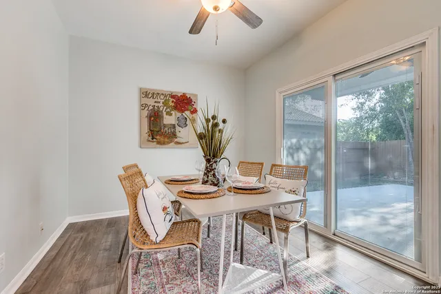 a view of a dining room with furniture wooden floor and chandelier