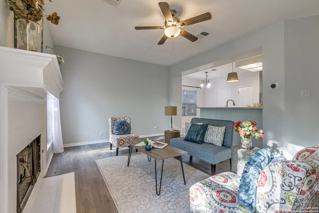 a living room with furniture and a fireplace