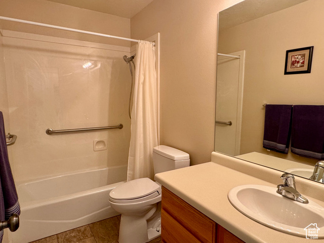 445 Topaz Boulevard, Unit 10 Delta, UT 84624 - Photo 19 of 28 Full bathroom featuring shower / bathtub combination with curtain, vanity, toilet, and tile patterned floors