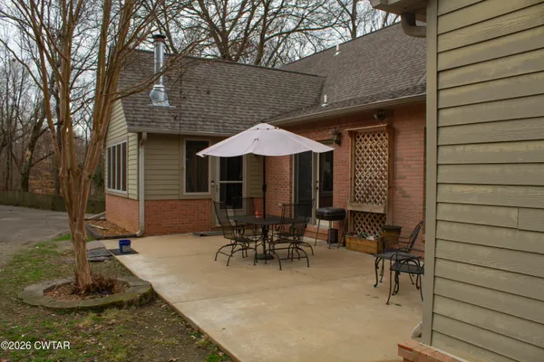 a view of house with yard and outdoor seating