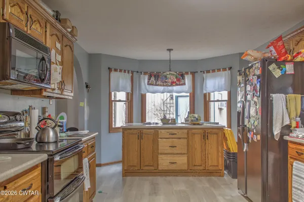 a kitchen with stainless steel appliances granite countertop a sink and a stove
