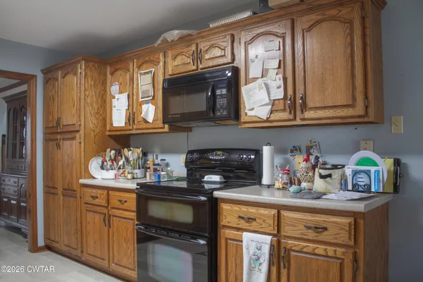 a kitchen with stainless steel appliances granite countertop a stove and cabinets