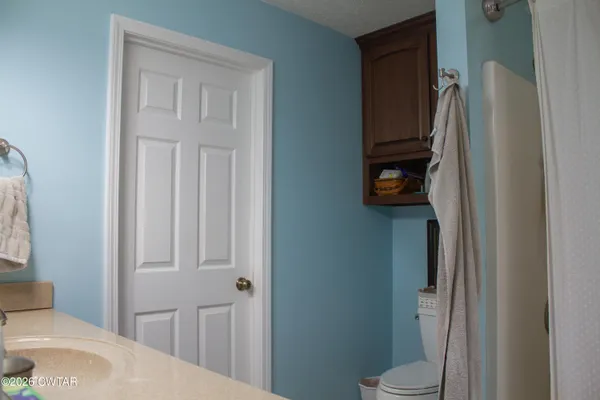 a bathroom with a sink vanity and mirror
