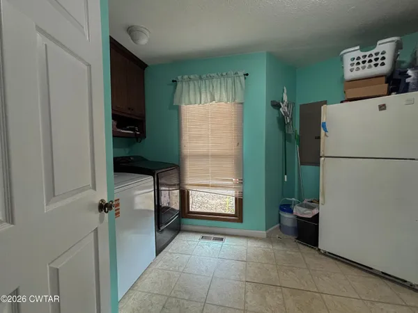a kitchen with refrigerator and stove