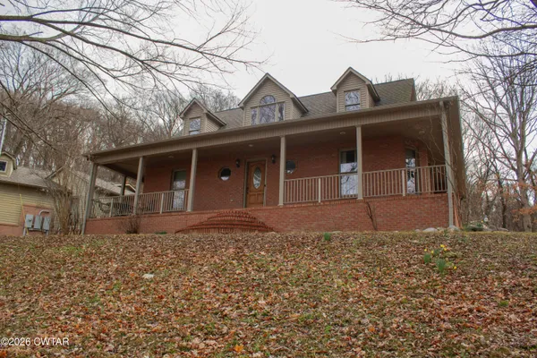 front view of a house with a bench