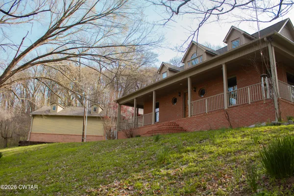 a view of staircase with railing and a painting on the wall